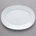 A Schonwald white porcelain oval platter with a curved edge.