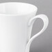 A close-up of a Schonwald white porcelain coffee cup with a handle.