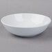 A Schonwald white porcelain bowl on a gray surface.