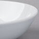A close-up of a Schonwald white porcelain bowl with a white rim.