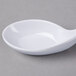 A white spoon on a white bowl.