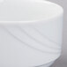 A close up of a Schonwald Donna white porcelain bouillon bowl with a wavy design on it.