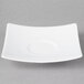 A white square Schonwald porcelain saucer with a circle in the middle.