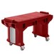A red Cambro Versa work table on wheels.