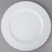 A Schonwald white porcelain plate with a white rim on a gray surface.