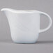 A Schonwald white porcelain creamer with a handle on a white surface.