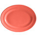 A coral oval Tuxton china platter with a white background.