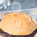 A hamburger with a WNA Comet clear plastic oval pick on top.