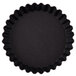 A black fluted tart pan with a black surface.