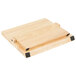 A Mercer Culinary Z&#252;M&#174; rubberwood cutting board with black accents and a magnetic strip with knives.