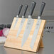 A Mercer Culinary knife set on a wooden magnetic board.