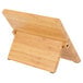 A Mercer Culinary bamboo tablet stand with a wooden board and black handle.