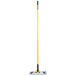 A Rubbermaid HYGEN microfiber mop with a yellow handle.