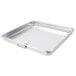 A silver aluminum Vollrath roasting pan with handles.