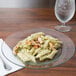 A Libbey Moderno glass plate with pasta and meat on it.