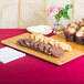 An American Metalcraft rectangular bamboo platter with cookies and muffins on a table.