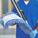A man in blue scrubs using a Rubbermaid HYGEN blue microfiber wet mop pad on a mop.