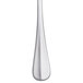 A Libbey stainless steel teaspoon with a white handle.