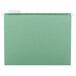A Smead bright green hanging file folder with repositionable poly tabs.