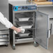 A chef putting food into an Alto-Shaam stackable oven.