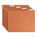 A row of orange Smead hanging file folders with white tabs.