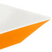 A white square bowl with orange and black lines.
