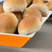 A GET Keywest melamine bowl filled with rolls of bread.