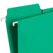 A green Smead FasTab hanging file folder with white hooks.