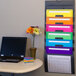 A laptop and a Smead plastic wall organizer with colorful files.