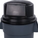 A black Carlisle Bronco dome top lid on a grey trash can.
