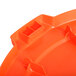 An orange plastic Carlisle Bronco trash can lid.