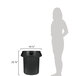 A woman standing next to a black Rubbermaid BRUTE trash can.