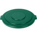 A green plastic Carlisle Bronco lid with handles on a green surface.