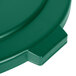 A close-up of a Carlisle green plastic lid for a trash can with a handle.