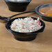 A Fabri-Kal SideKicks bowl of food with a plastic lid.