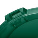 A green plastic lid for a Carlisle Bronco trash can with a hole in it.