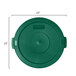 A green Carlisle flat round plastic lid for a trash can with a small hole in the center.