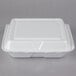A white Dart foam take out container with a hinged lid.