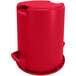 A red Carlisle Bronco round plastic trash can with a lid.