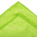 A green microfiber cloth with a green stitched edge.