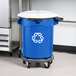 A blue Rubbermaid BRUTE recycling bin with white lid and wheels.