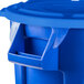 A blue Rubbermaid recycling can with a lid.