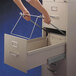 A person using Smead file drawer handles to open a file cabinet.