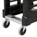 A black plastic cart with white wheels.