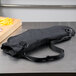 A black bag with a strap and a Dexter-Russell knife on it.