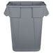 A close-up of a Rubbermaid grey square trash can with a lid.