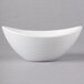 A 10 Strawberry Street Whittier white porcelain boat bowl with a curved edge.