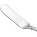 A silver butter knife with a white handle.