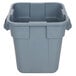 A Rubbermaid gray plastic square trash can with a handle.