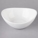 A white 10 Strawberry Street Whittier porcelain bowl with an oval shape on a white surface.